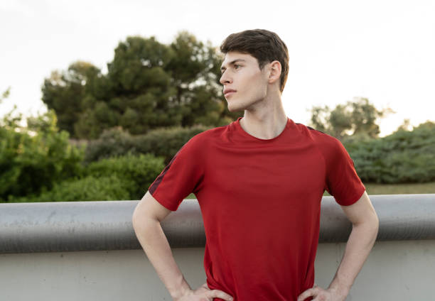 Caucasian male runner preparing to run outdoors at dawn.