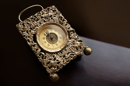 Antique pocket watch from 1917 on black background.
