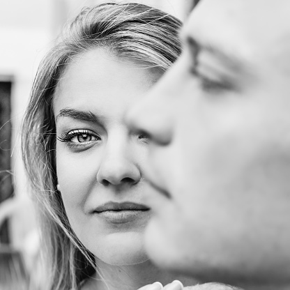 face of the guy in the foreground. close-up face of the girl. black and white photo.