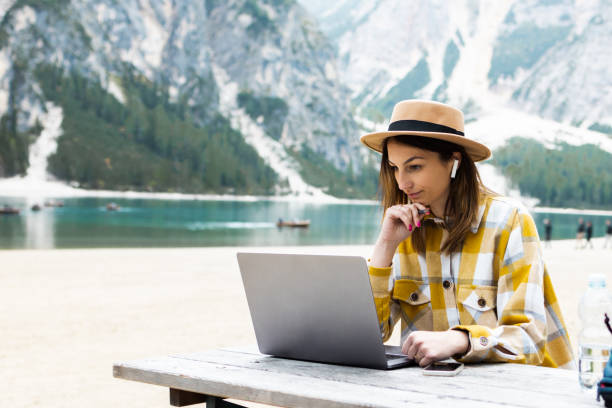 istock Young woman learning online while staying on the mountain 1428669035