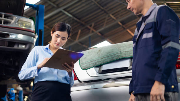 female customer shakes hands with a service claim employee at car repair service and auto store shop. - insurance car insurance agent auto accidents imagens e fotografias de stock