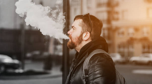 istock man with a backpack smokes in the city 1428670737