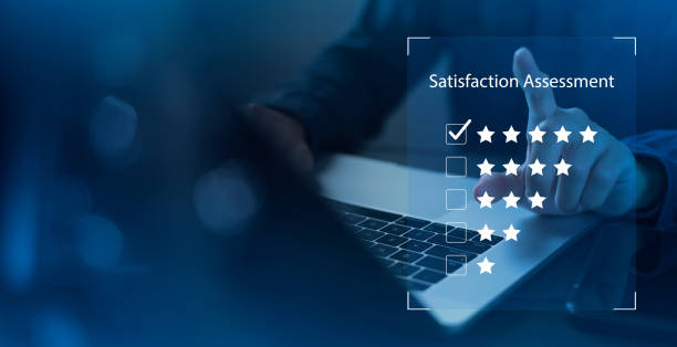 istock Satisfaction and customer service survey concept, business people using  laptop. to answer the questionnaire And the satisfaction rating, the satisfaction rating with the smiley face icon 5 stars. 1428671008