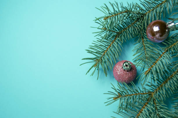 istock Christmas tree branch with toys on blue background. Top view. Space for text 1428672029