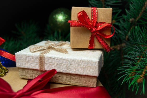 istock Christmas holidays composition with gift boxes and coniferous tree branch. Happy New Year and Merry Christmas concept 1428672247