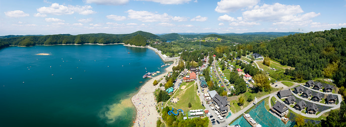 Vacations in Poland - beach near the water dam on the Solina Lake, Bieszczady Mountains in background