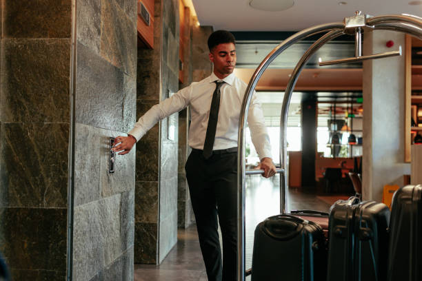 istock Hotel attendant at elevator with baggage cart. 1428673463
