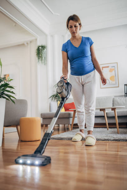 istock Cleaning house with cordless stick vacuum cleaner 1428674618