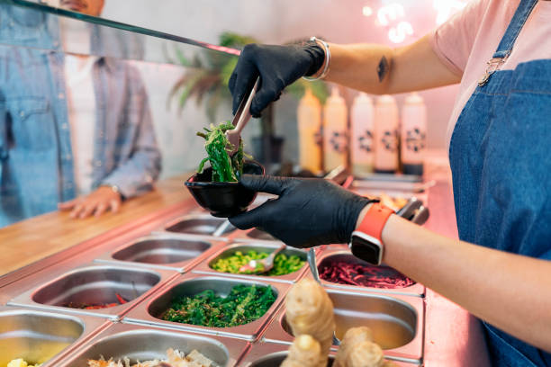 istock Woman Adding Ingredients Into Poke Bowl 1428677048