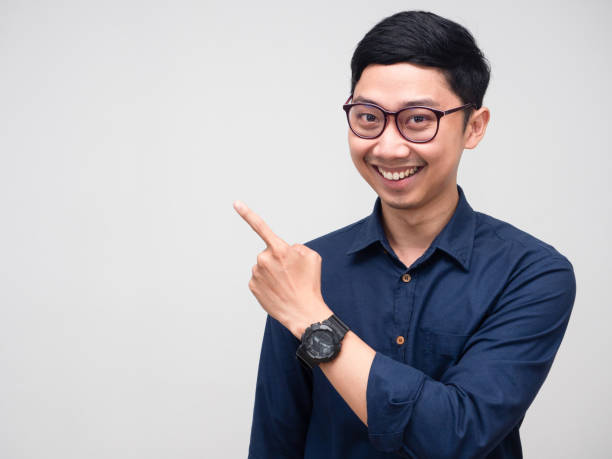 istock Portrait businessman smile gesture point finger at copy space 1428678347