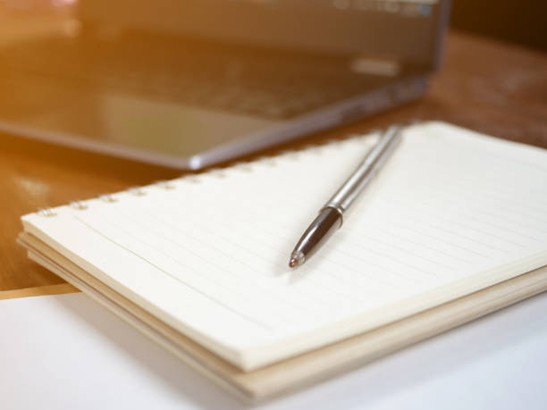 istock Closeup workspace on table,Pen with diary and laptop on workspace 1428679103