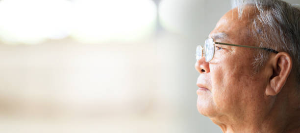 istock Lonely elderly male looking outside the window. 1428686293