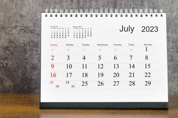 The July 2023 Monthly desk calendar for 2023 year on wooden table. stock photo
