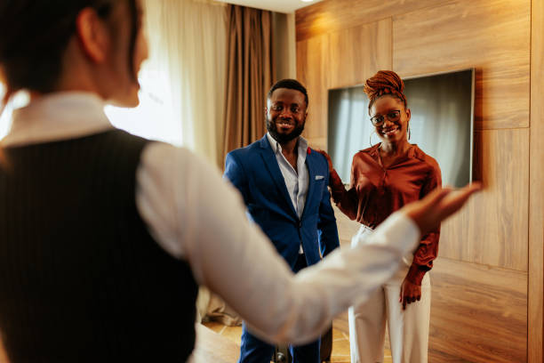 istock Concierge showing guests around hotel. 1428689712