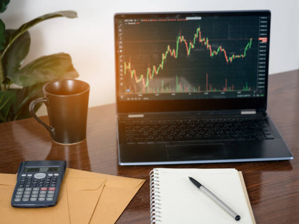 istock Laptop financial graph with book on table,Workspace business 1428691188