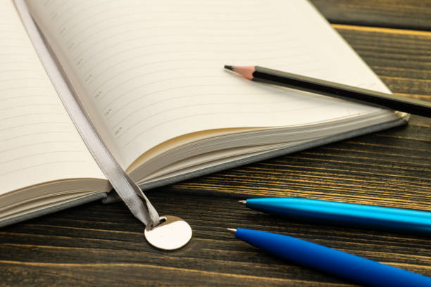 istock Diary for notes on a wooden table, pen and pencil 1428692040