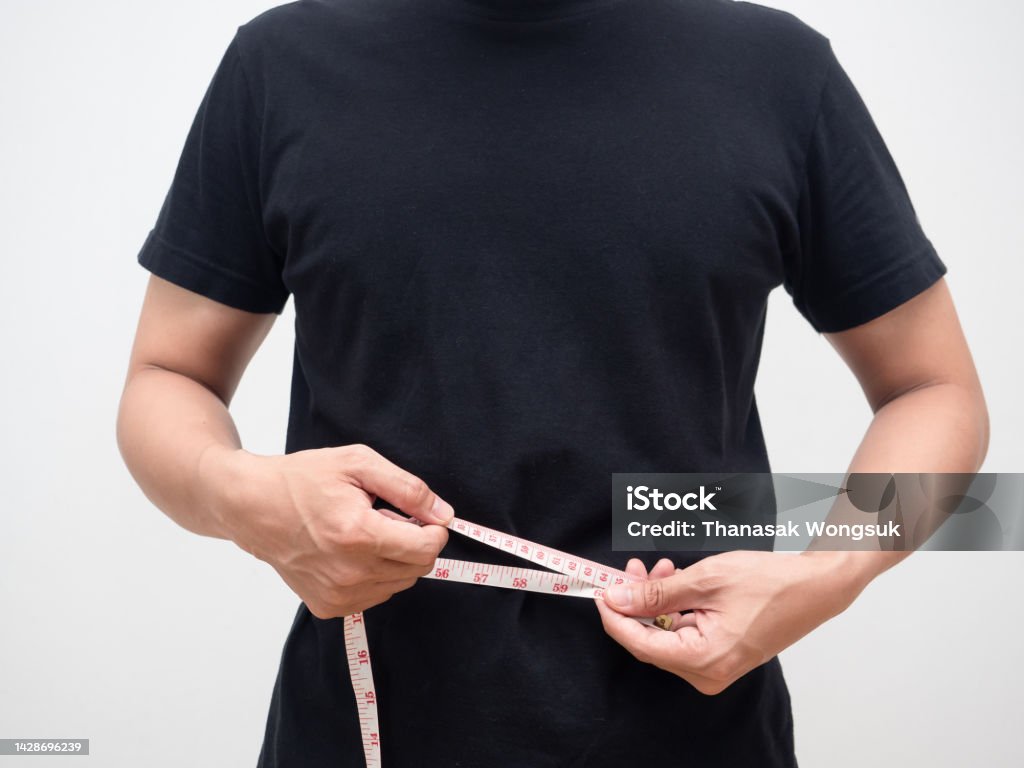 Man using measure tape body for checking his waist studio shot Tape Measure Stock Photo