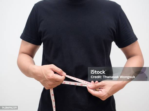 Man Using Measure Tape Body For Checking His Waist Studio Shot Stock Photo - Download Image Now