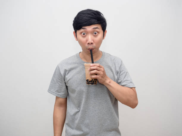 istock Asian man drinking boba tea isolated 1428696528