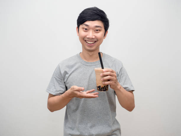 istock Young man holding bubble tea dessert happy smile 1428696540