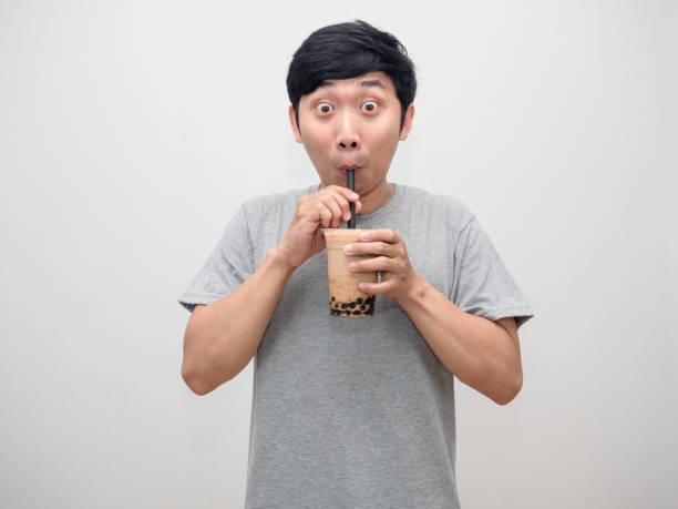 istock Young man gesture sucking boba tea in hand feels fresh isolated 1428696675