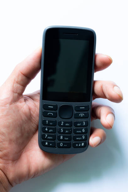 istock mobile phone in human hand isolated on a white background,human hand holding a simple mobile phone isolated on white background, 1428698662
