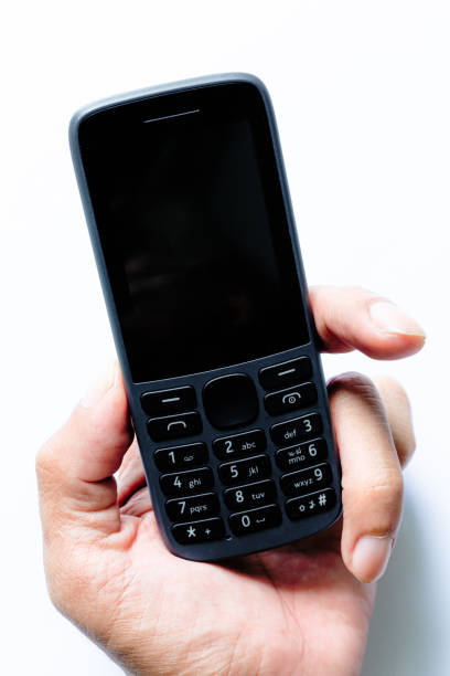 istock mobile phone in human hand isolated on a white background,human hand holding a simple mobile phone isolated on white background, 1428698668