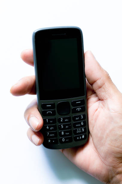 istock mobile phone in human hand isolated on a white background,human hand holding a simple mobile phone isolated on white background, 1428698964