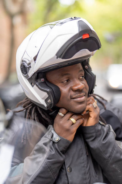 istock Man on motorcycle fastening safety helmet 1428699761