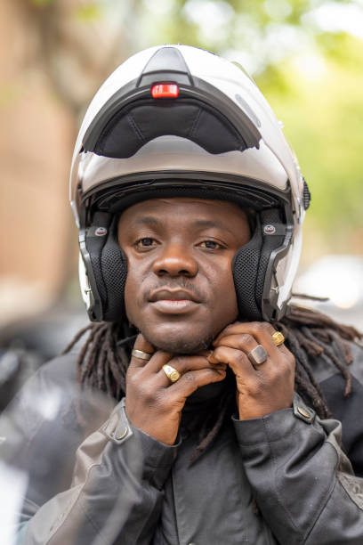 istock Man on motorcycle fastening safety helmet 1428699781