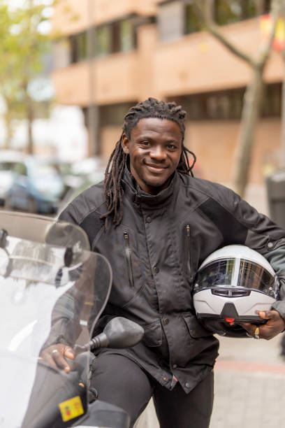 istock Man posing with helmet on motorcycle 1428699805