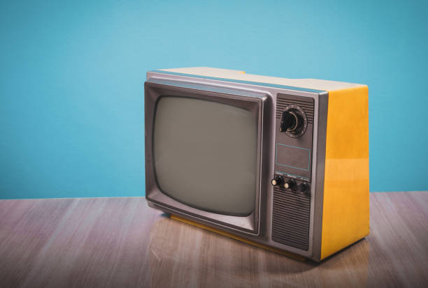 istock Retro yellow old tv on wooden table 1428702703
