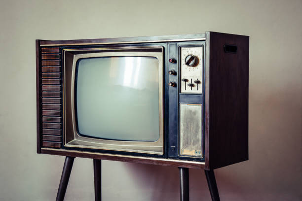 istock Old television standing on wall background, Classic retro old tv technology with wood case. 1428702764