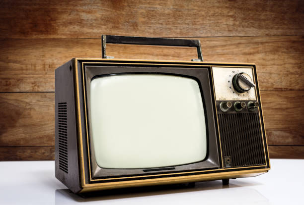 istock Old vintage tv on wooden  background 1428702825