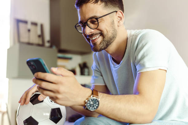 istock A young man holding mobile phone and betting online 1428702901