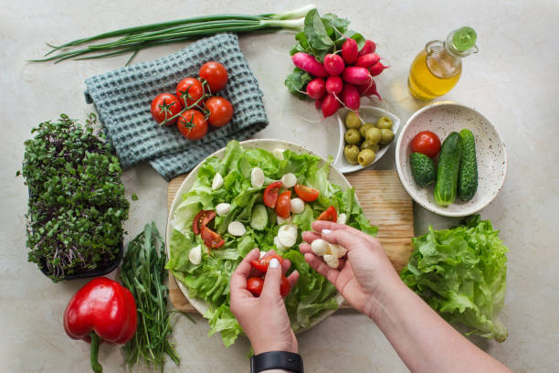istock Preparing a vegetable salad with tomato and mozzarella 1428716355