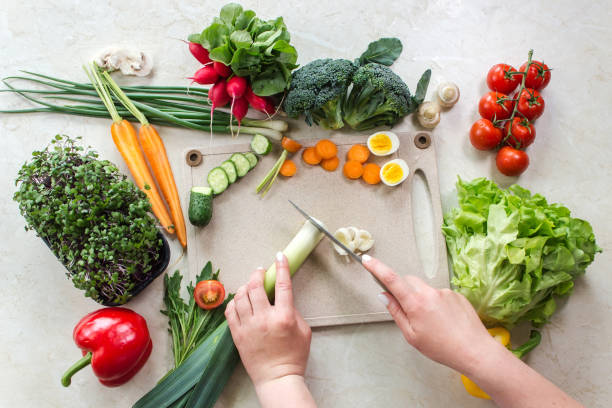 istock Healthy food and cutting vegetable ingredients on white table 1428716657