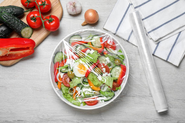 https://media.istockphoto.com/id/1428718811/photo/bowl-of-fresh-salad-with-plastic-food-wrap-on-white-wooden-table-flat-lay.jpg?s=612x612&w=0&k=20&c=RSOAkUVPC6JNvEGqpL5FAGPvgMuo6xepenDci9ZzAS0=
