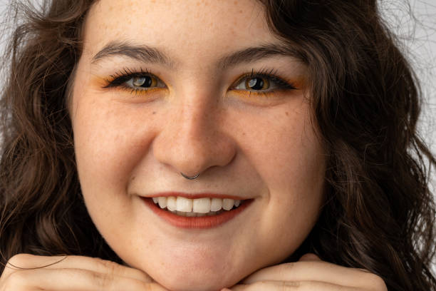 istock Beautiful young woman smiling into camera 1428719397