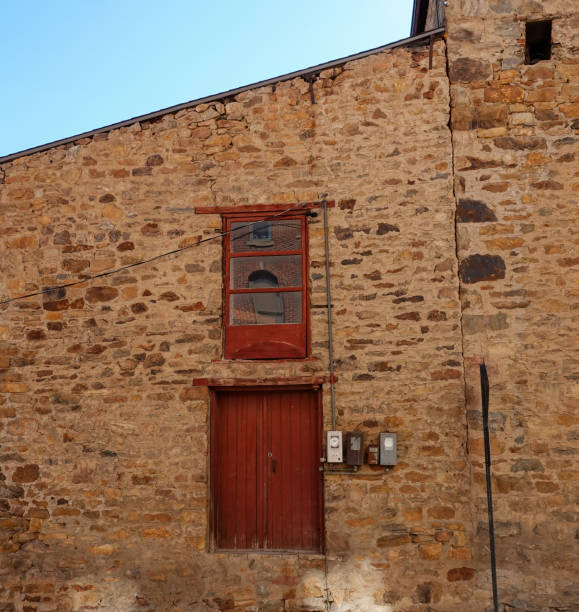 istock Loading doors on an abandoned  and leaning 19th century stone building in the National Historic District of Central City, Colorado 1428719647