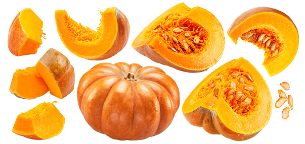 Orange round pumpkins and pumpkin slices and seeds isolated on white background. File contains clipping paths.