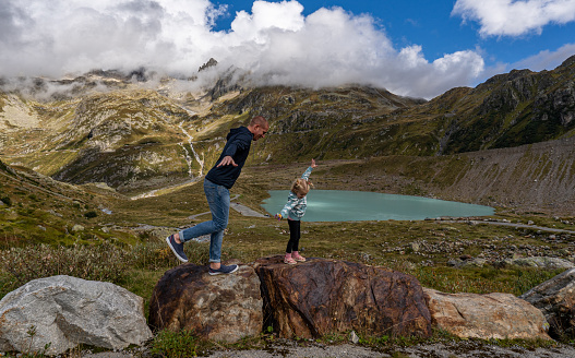 Father and daughter being silly at Susten Pass in the beautiful Swiss Alps around the Stein Glacier and Steinsee Lake of Switzerland.