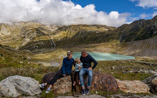 Mother, father, and daughter being silly at Susten Pass in the beautiful Swiss Alps around the Stein Glacier and Steinsee Lake of Switzerland.