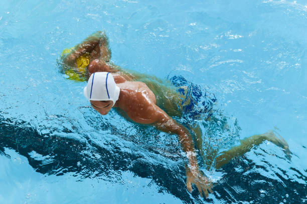 istock A water polo defense player holds a ball underwater. 1428724353