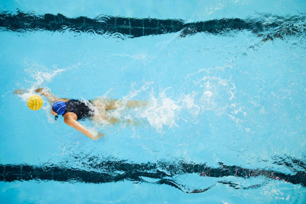 istock A water polo female forward player drives the ball. 1428724467