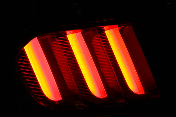 istock Beautiful bright burning car lights on a black background. 1428724592