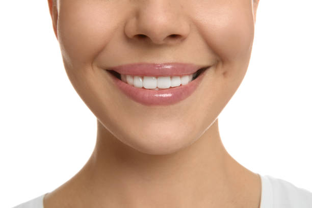 istock Young woman with healthy teeth on white background, closeup 1428724718