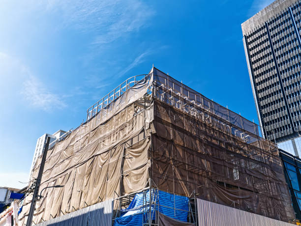 istock Low Angle View of Under Construction Building with Scaffolding Against Blue Sky 1428727278