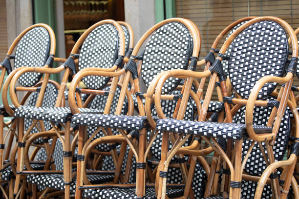 Stack of rattan cafe chairs Chairs in a stack outside a closed cafe in Bilbao, Spain stackable stock pictures, royalty-free photos & images