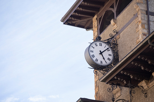 Clock on the wall of a brick-patterned building